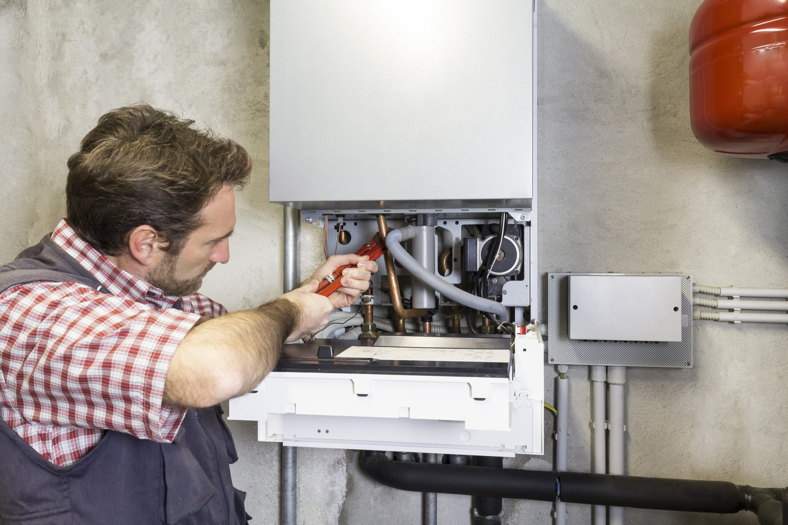 plumber repairing a condensing boiler